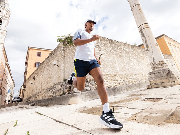 A participant in the run is running confidently in an old town