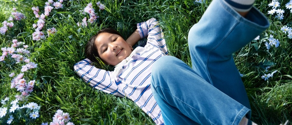 Person relaxing on green grass