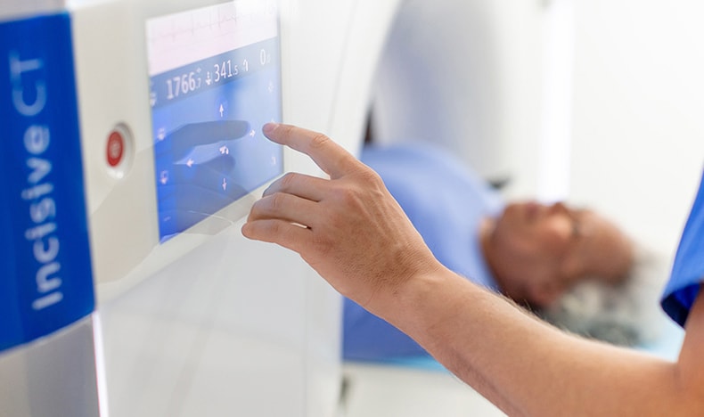 Download image (.jpg) (opens in a new window) Two doctors reviewing mammogram case