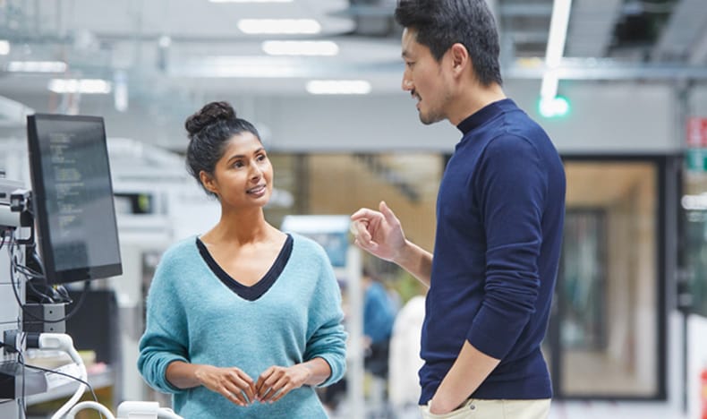 2 persons talking about results