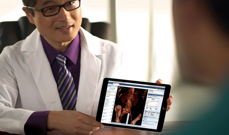 Download image (.jpg) (opens in a new window) Two doctors reviewing mammogram case