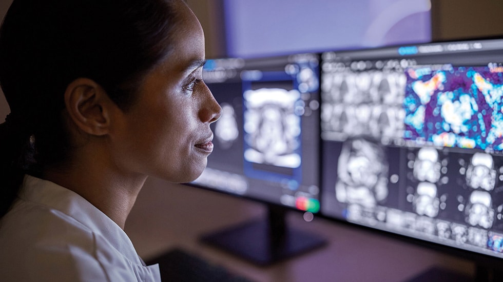 Download image (.jpg) (opens in a new window) Two doctors reviewing mammogram case