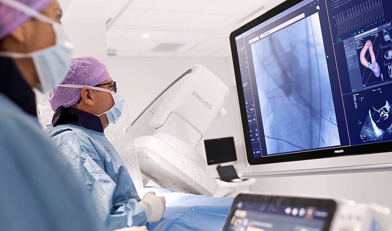 Download image (.jpg) (opens in a new window) Two doctors reviewing mammogram case