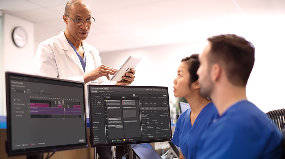 Download image (.jpg) (opens in a new window) Two doctors reviewing mammogram case