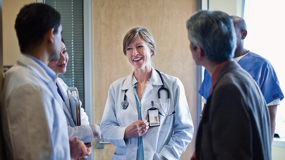 Download image (.jpg) (opens in a new window) Two doctors reviewing mammogram case