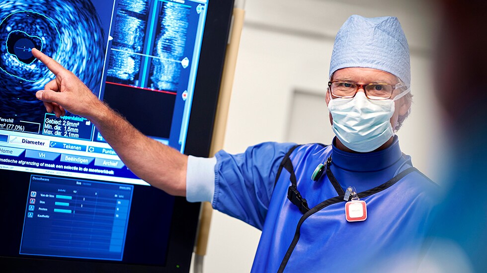 Download image (.jpg) (opens in a new window) Two doctors reviewing mammogram case