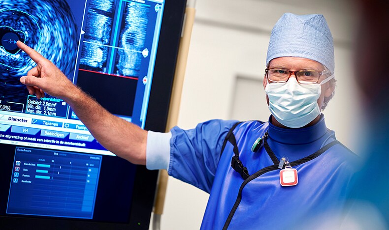 Download image (.jpg) (opens in a new window) Two doctors reviewing mammogram case