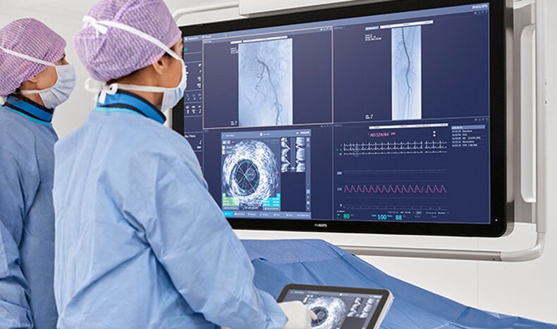 Download image (.jpg) (opens in a new window) Two doctors reviewing mammogram case