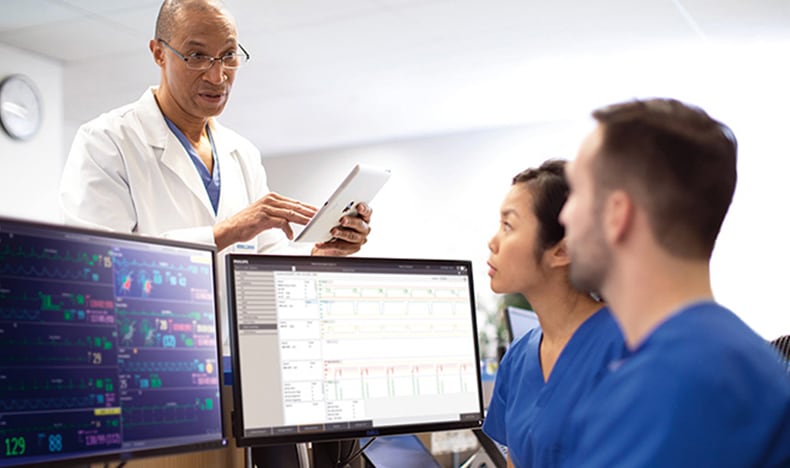 A care team discussing patient monitoring data