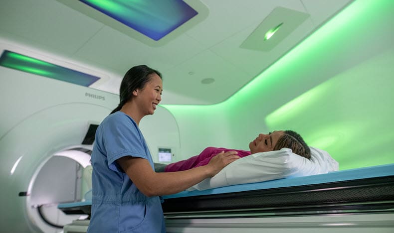 Philips Ambient CT7500 being used by a clinician with a patient for enhanced diagnostic confidence through spectral-detector CT