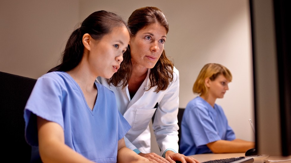 Radiologists inspecting an image on a screen