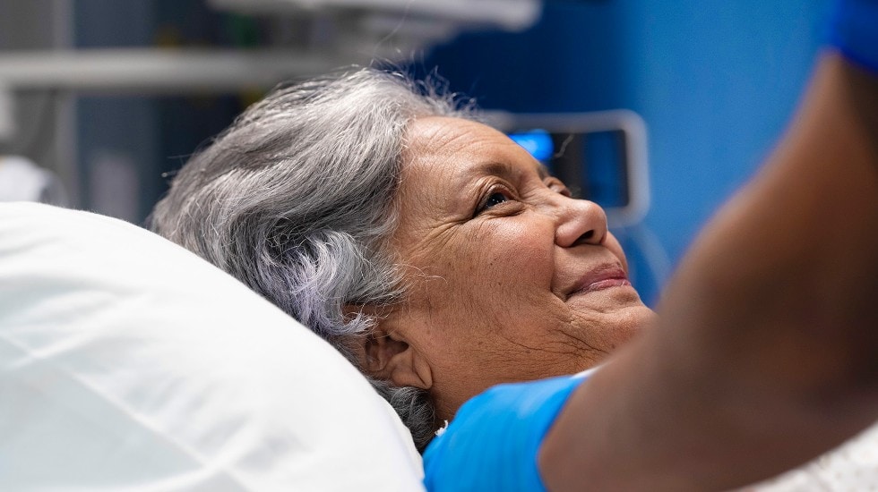 An elderly woman in a hospital bed