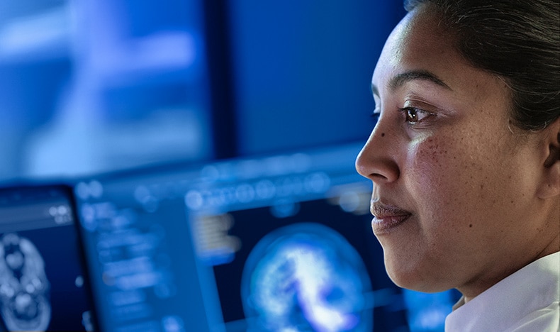 A female radiologist looking at a screen 