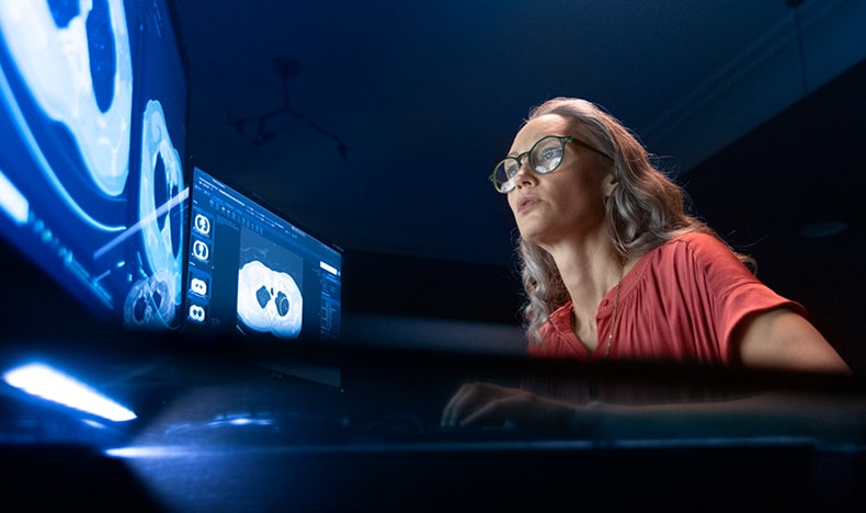A female radiologist looking at a screen 