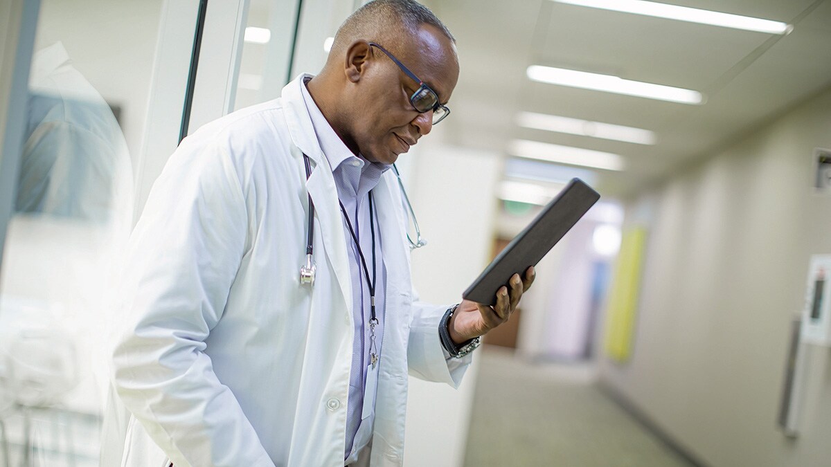 Download image (.jpg) (opens in a new window) Two doctors reviewing mammogram case