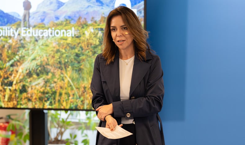Philips Chief Medical Officer Carla Goulart Peron speaks in front of a blue Philips sign during a Sustainability Education Session.