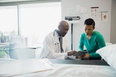Doctor and patient looking at digital tablet