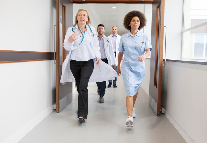 Doctors and nurse walking in hospital corridor