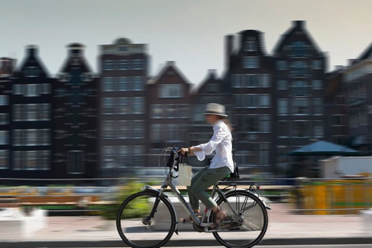 Blurred view of bicyclist on Amsterdam street, Netherland