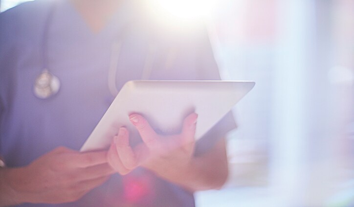 Doctor Using Digital Tablet In Hospital