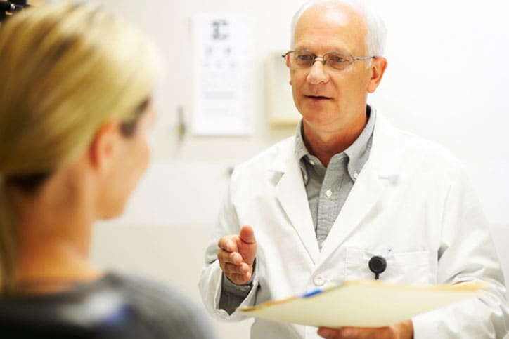 Mature doctor having a discussion with patient