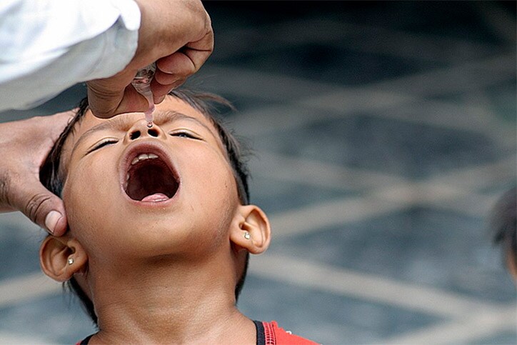 Girl getting polio drops