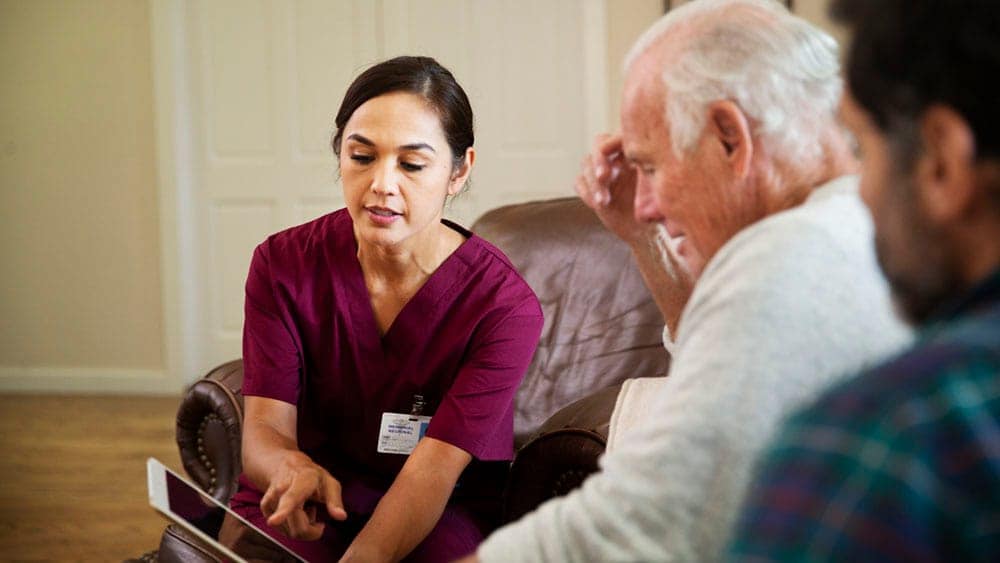 Download image (.jpg) (opens in a new window) Two doctors reviewing mammogram case