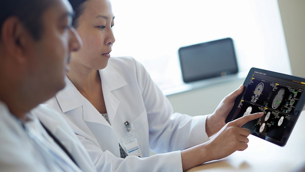 Download image (.jpg) (opens in a new window) Two doctors reviewing mammogram case