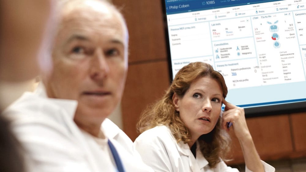 Download image (.jpg) (opens in a new window) Two doctors reviewing mammogram case