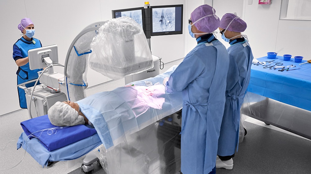 Download image (.jpg) (opens in a new window) Two doctors reviewing mammogram case
