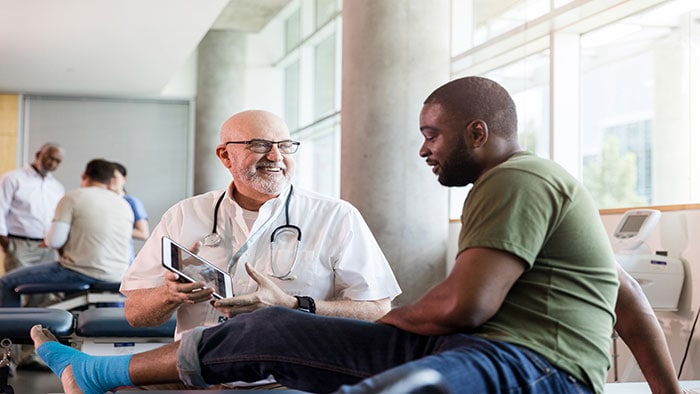 A clinician in consultation with a patient -  
