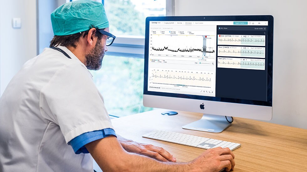 A cardiologist reviews an ECG readout report with AI-assisted analysis