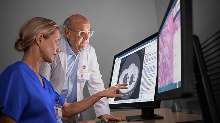 Oncologist and radiologist reviewing scans -  