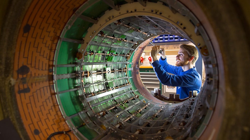 Man makes a repair inside a large medical devise