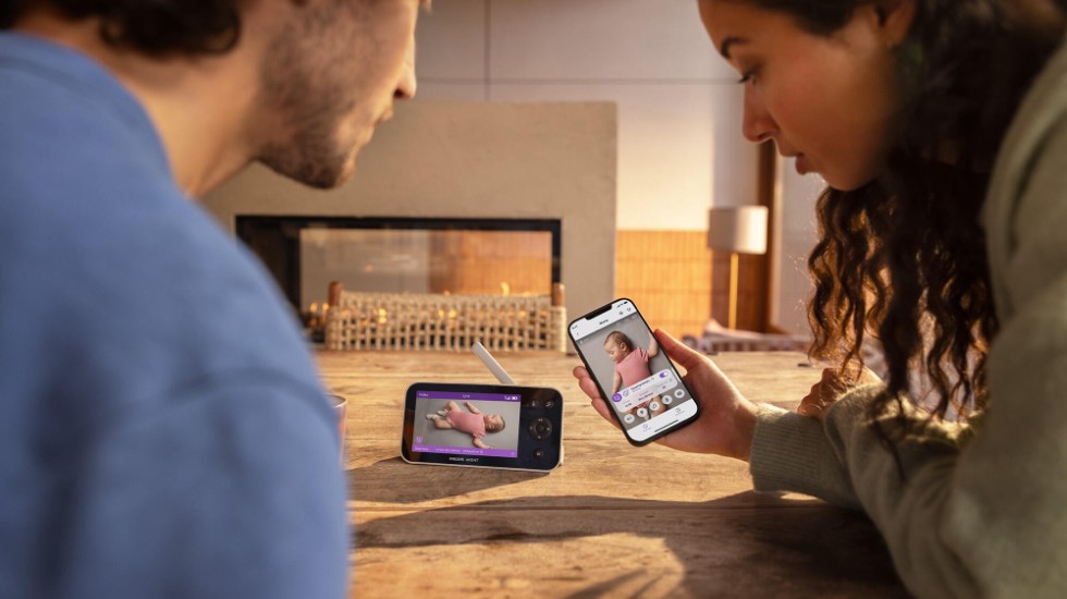 Parents checking baby monitor quietly during rest time