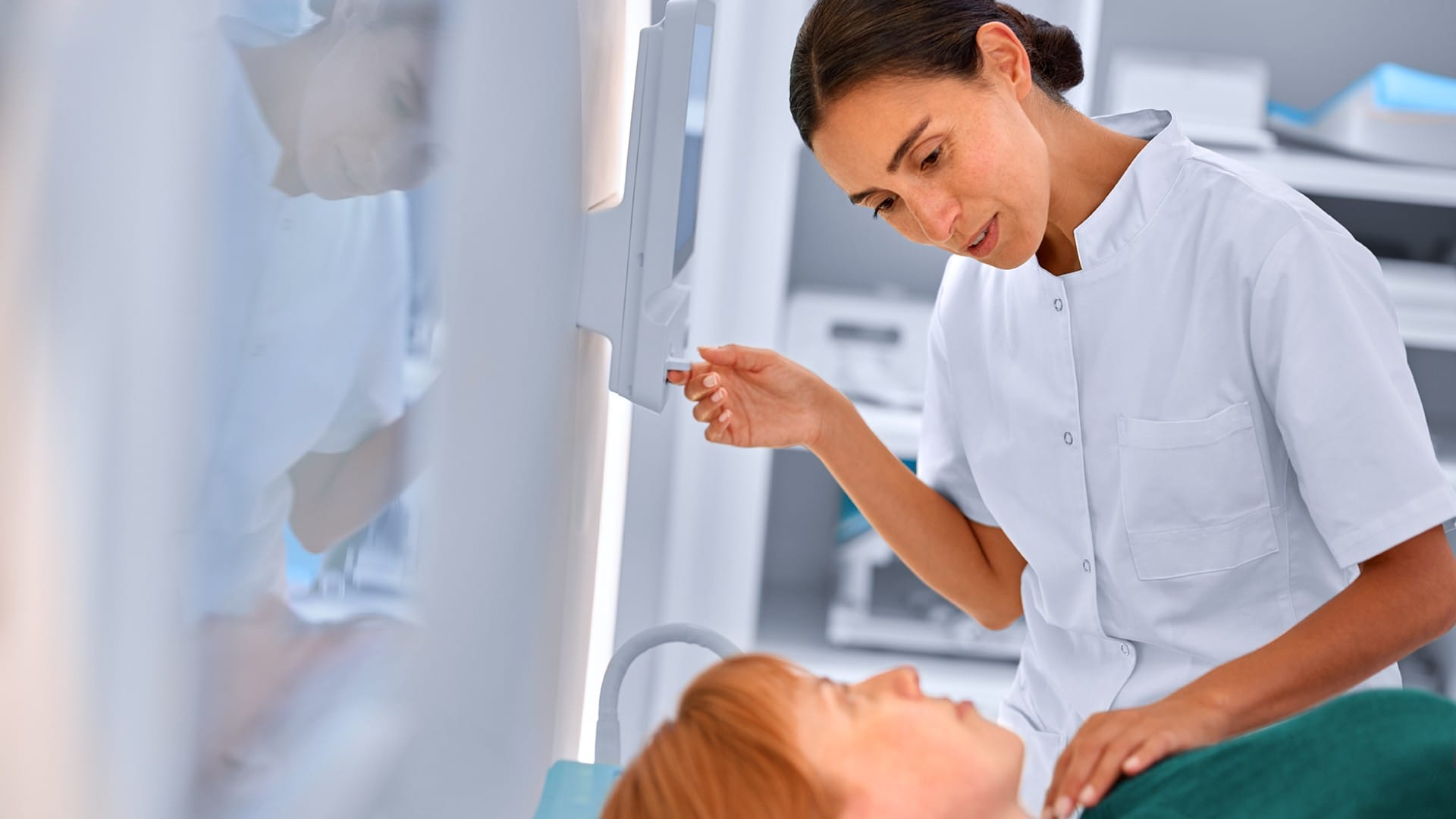 Technician prepares patient for MR scan