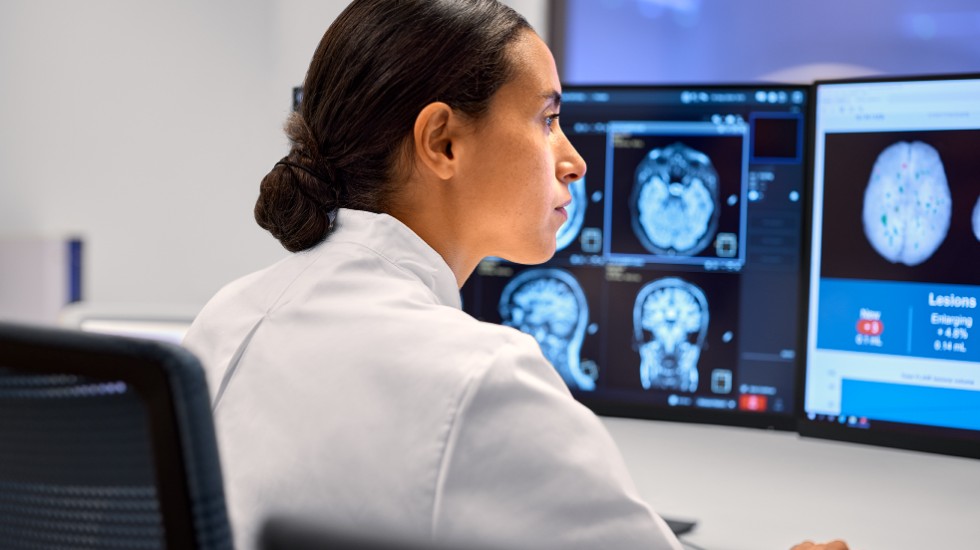 Technician reviews MR scan
