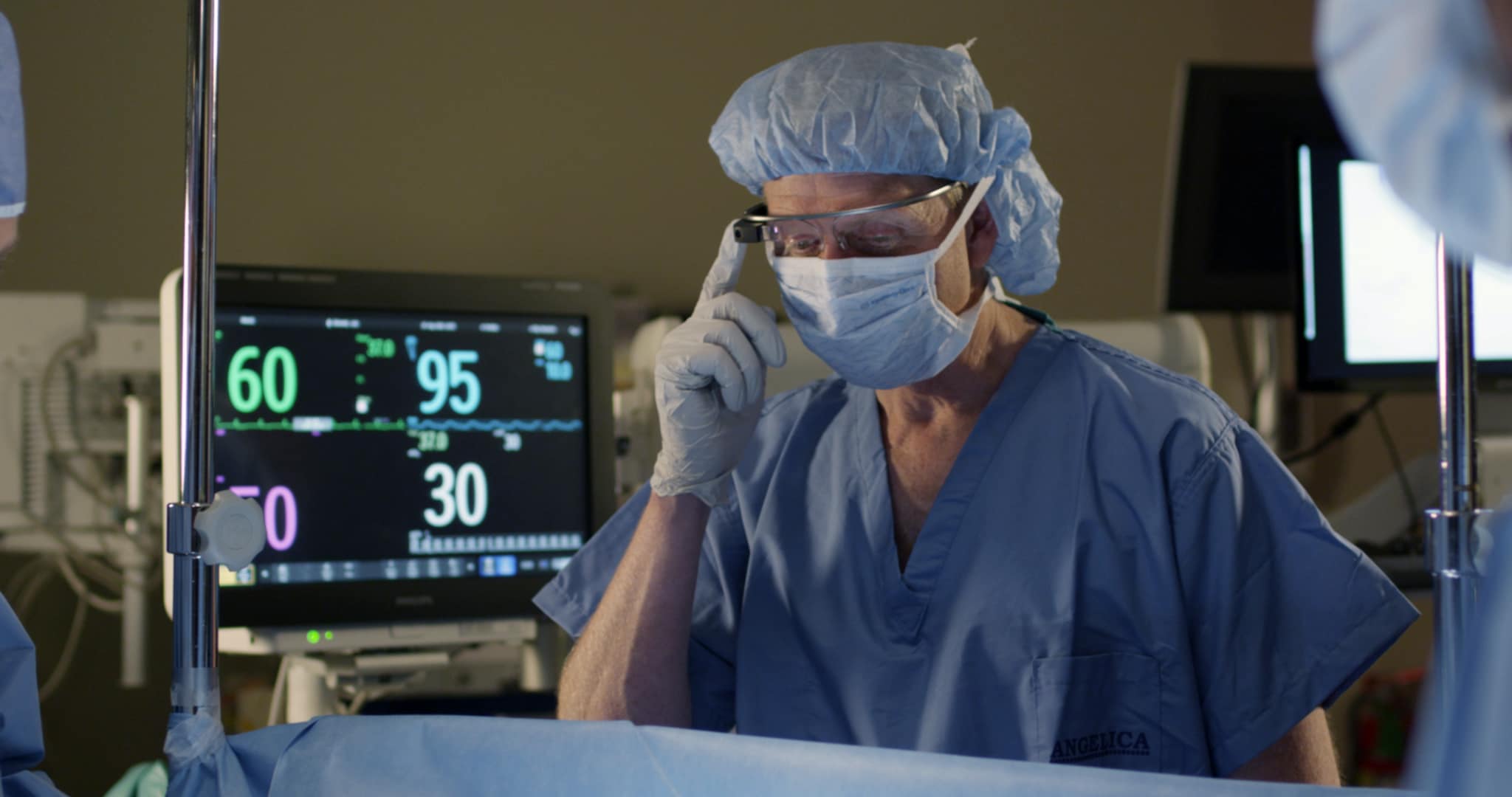 Anesthesiologist viewing vital signs during surgery